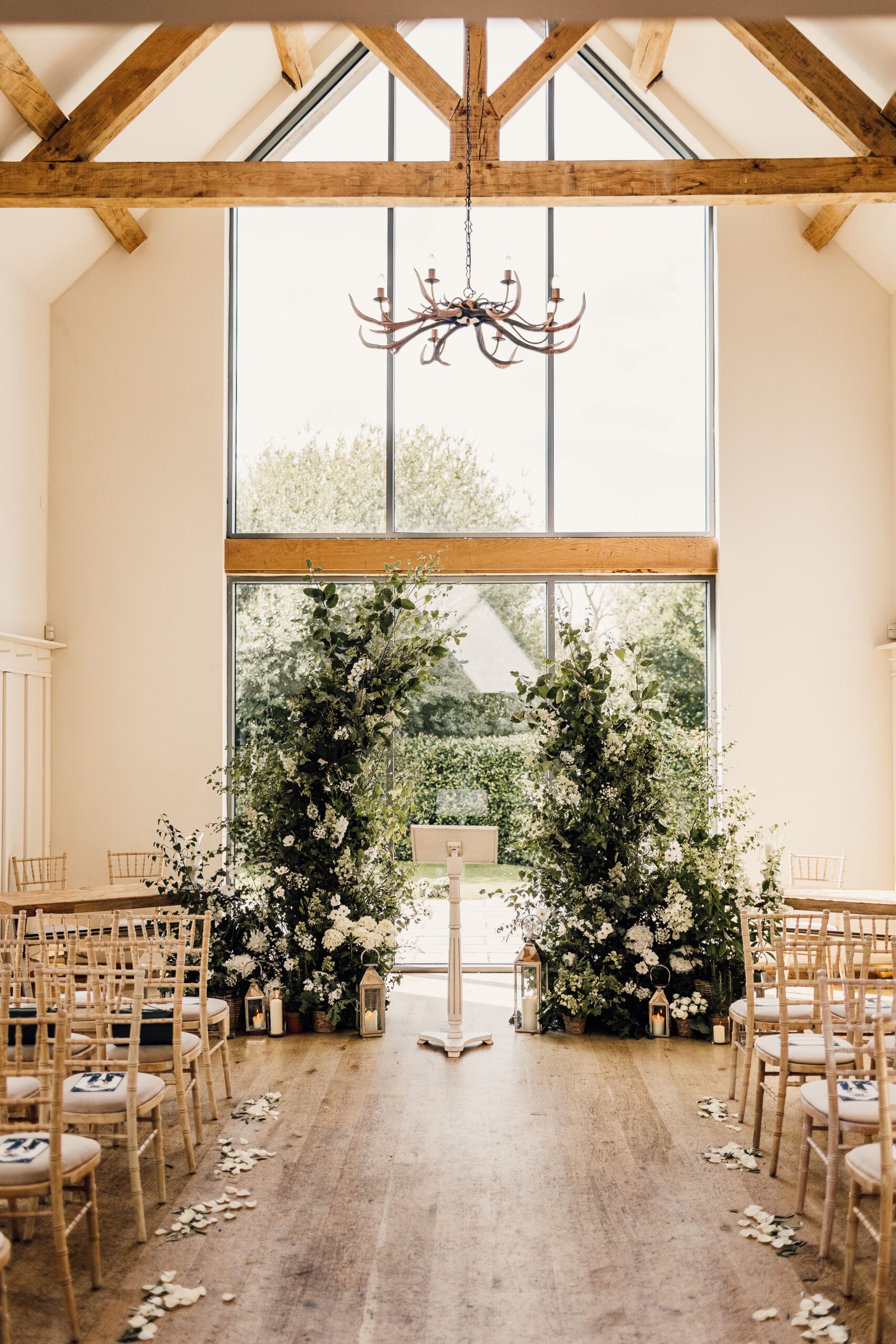 Abundance of flowers by Meadowfolk. Same sex wedding ceremony set up.