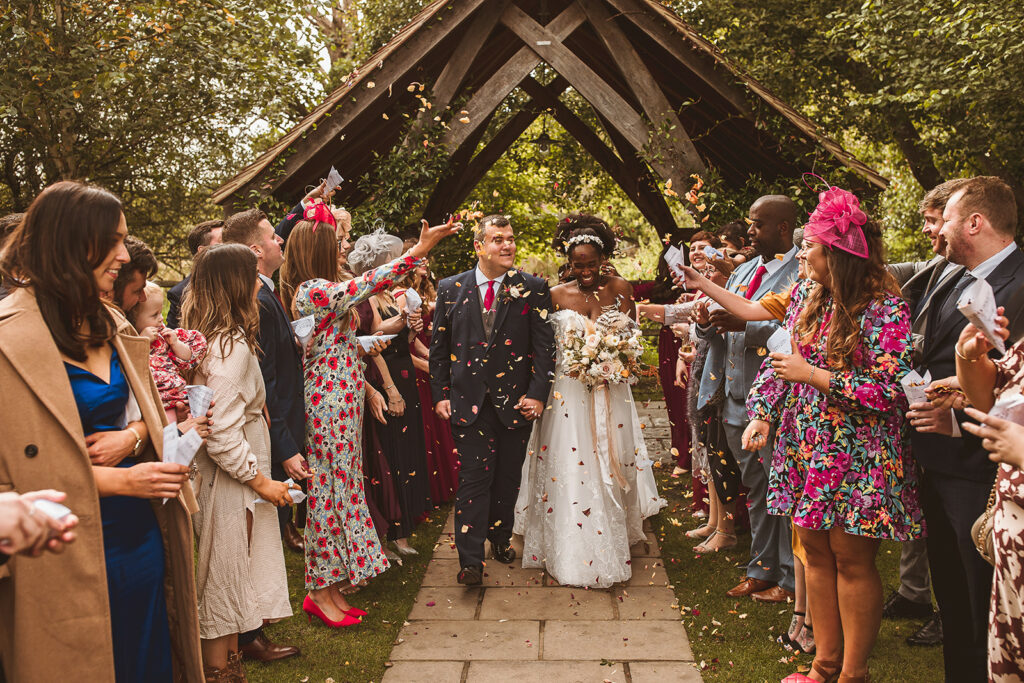 couple walk down the aisle at Millbridge Court